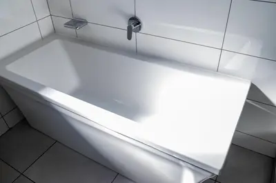 a white bath tub in a white tiled bathroom at Spacious 2 Bedroom Apartment in Midrand, Waterfall City - Business and Family friendly - 14A Elizabeth Place in Midrand