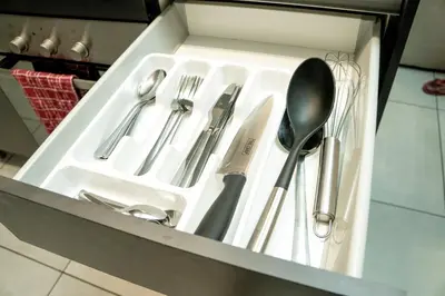 a drawer filled with silver utensils in a kitchen at Spacious 2 Bedroom Apartment in Midrand, Waterfall City - Business and Family friendly - 14A Elizabeth Place in Midrand