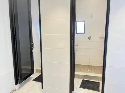 a shower stall with a glass door in a bathroom at Spacious 2 Bedroom Apartment in Midrand, Waterfall City - Business and Family friendly - 14A Elizabeth Place in Midrand