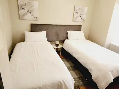 two beds sitting next to each other in a room at Sable woods in Pretoria