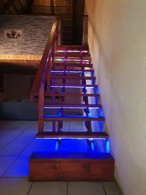 a set of stairs with blue lights on them at Falcon Lodge Bela Bela in Merinovlakte
