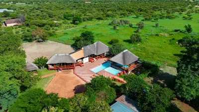 an aerial view of a house with a swimming pool at Falcon Lodge Bela Bela in Merinovlakte