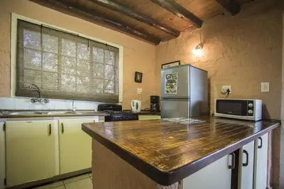 a kitchen with a counter top and a refrigerator at Majuli River Lodge - overlooking Kruger Park in Marloth Park
