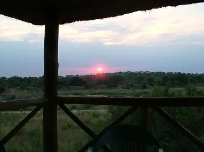 a view of the sunset from a window of a hut at Majuli River Lodge - overlooking Kruger Park in Marloth Park