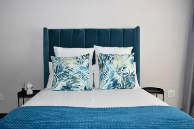 a bed with blue and white sheets and pillows at Walford Estate, Spacious Private, Modern luxury living in Midrand