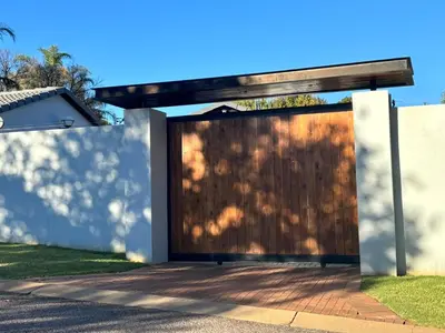 a wooden garage door on the side of a house at Spacious Room in Pretoria East in Pretoria