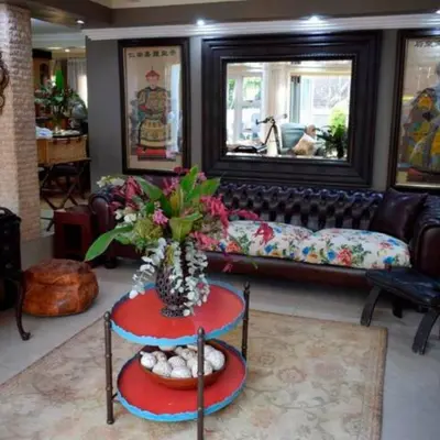 a living room with a couch and a table at The Giraffe Room at Frederick's Place in Pretoria