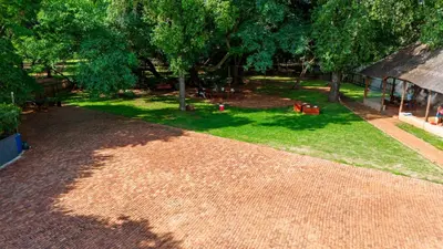 an aerial view of a yard with trees and grass at Falcon Lodge PK in Bela-Bela