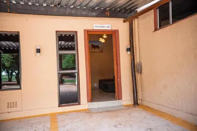 an entrance to a house with an open door at Falcon Lodge PK in Bela-Bela