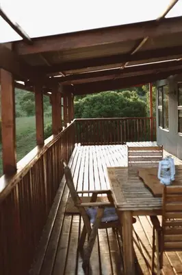 a wooden deck with a table and chairs on it at Die Boothuis at Lake Chrissie in Lake Chrissie
