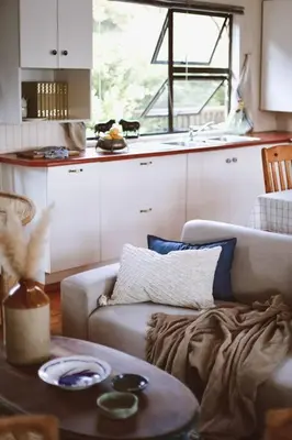a living room with a couch and a table at Die Boothuis at Lake Chrissie in Lake Chrissie