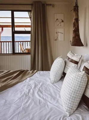 a bedroom with a bed with two pillows on it at Die Boothuis at Lake Chrissie in Lake Chrissie