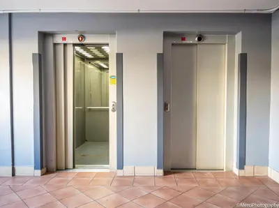 three elevators in a building with their doors open at Premium Getaway at Menlyn Maine in Pretoria