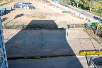 a view of a parking lot behind a fence at Premium Getaway at Menlyn Maine in Pretoria