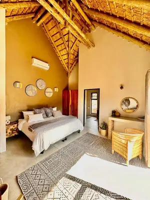 a bedroom with a large bed in a room at Pumba Lodge Hoedspruit in Hoedspruit