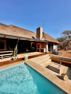 a backyard with a pool and a house at Pumba Lodge Hoedspruit in Hoedspruit