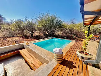 a small swimming pool on a wooden deck at Pumba Lodge Hoedspruit in Hoedspruit