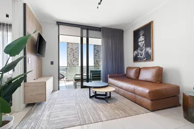 a living room with a couch and a table at Ellipse Waterfall 3909 in Midrand