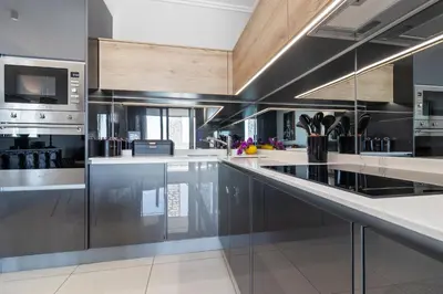 a large kitchen with stainless steel appliances and wooden ceilings at Ellipse Waterfall 3909 in Midrand