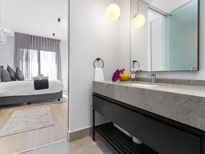 a bathroom with a sink and a large mirror at Ellipse Waterfall 3909 in Midrand