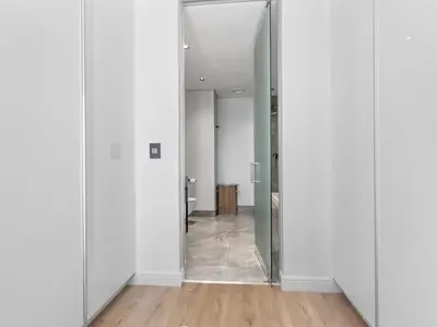 an open hallway with white walls and a mirror at Ellipse Waterfall 3909 in Midrand