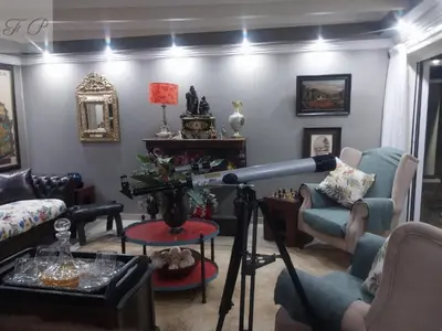 a living room with a telescope in a room at The Presidential Suite at Frederick's Place in Pretoria