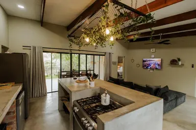 a kitchen with a stove and a counter top at Afri Villa Stays - Luxury Bush Villa Bird in Marloth Park