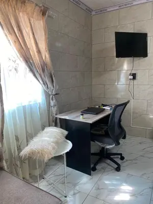 an office with a desk and a chair and a window at Whizzy Lifestyle Lodge in Witbank