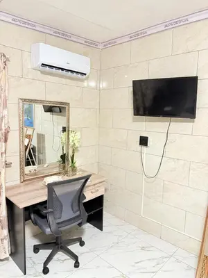 an office with a desk and a tv on a wall at Whizzy Lifestyle Lodge in Witbank