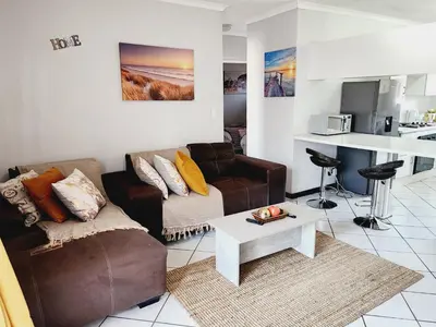 a living room with a couch and a coffee table at Olympus Side in Pretoria