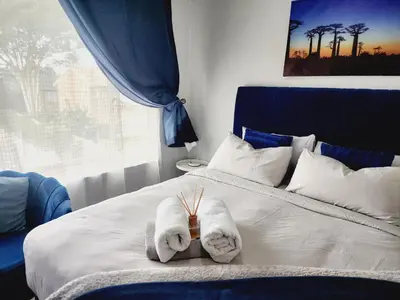 a bedroom with a bed with towels on it at Olympus Side in Pretoria