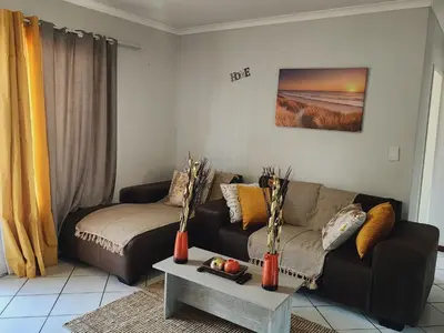 a living room with a couch and a table at Olympus Side in Pretoria