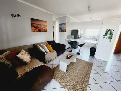 a living room with a couch and a table at Olympus Side in Pretoria