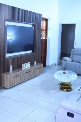 a living room with a large television and a coffee table at Wood Valley in Midrand