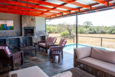 a living room with a couch and a fireplace at Casa de la Presa 1 in Polokwane