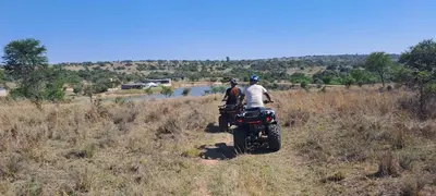 two people riding a motorcycle on a field at Casa de la Presa 1 in Polokwane