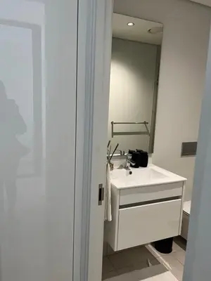 a bathroom with a white sink and a mirror at Ellipse waterfall midrand in Midrand
