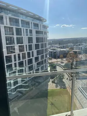 a view of a tall building from a window at Ellipse waterfall midrand in Midrand