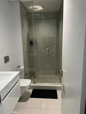 a bathroom with a glass shower with a toilet at Ellipse waterfall midrand in Midrand