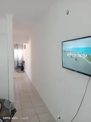 a flat screen tv hanging on a wall in a room at 7 Geelhout Ave in Nelspruit
