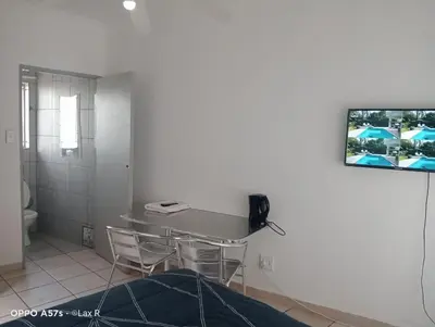 a room with a table and chairs and a tv on the wall at 7 Geelhout Ave in Nelspruit