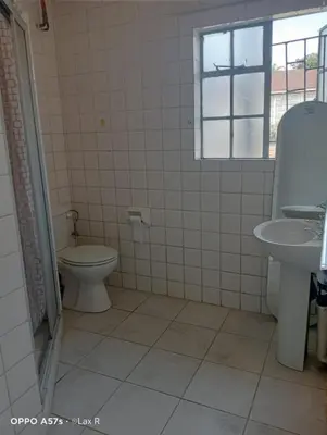 a bathroom with a toilet and a sink at 7 Geelhout Ave in Nelspruit