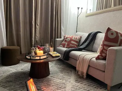 a living room with a couch and a table at Cozy retreat in Carlswald 264 in Midrand