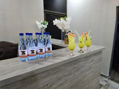 a group of bottles of water on a table with drinks at Nyamankulu Guest Lodge in Thulamahashi