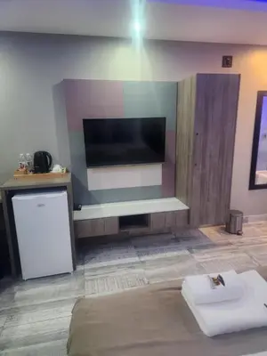 a living room with a flat screen tv on a wall at Nyamankulu Guest Lodge in Thulamahashi