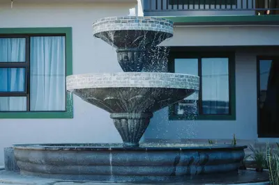 a water fountain in front of a building at Nyamankulu Guest Lodge in Thulamahashi