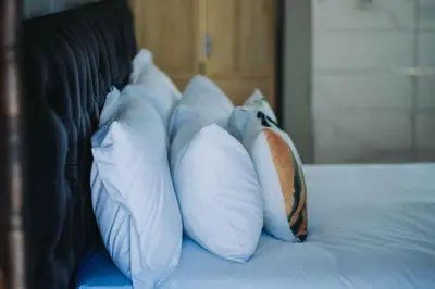 a group of pillows sitting on top of a bed at Nyamankulu Guest Lodge in Thulamahashi