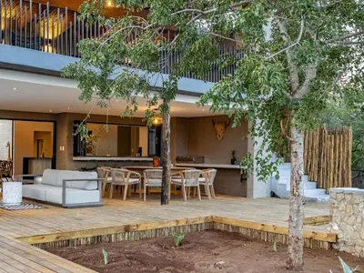 an outdoor patio with a table and chairs at Nare Bush Lodge in Marloth Park