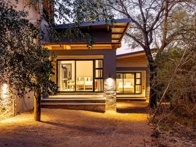 a house with a view of the front of it at Nare Bush Lodge in Marloth Park