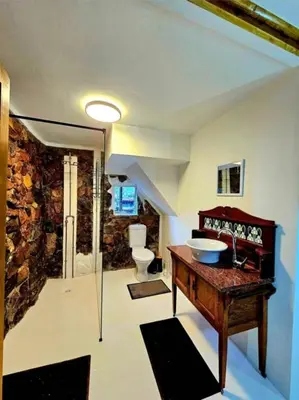 a bathroom with a sink and a toilet in it at Luxury GuesthouseCo FlintstoneHouse in Marloth Park